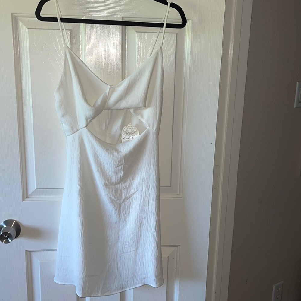 White dress with front cut out, size large.